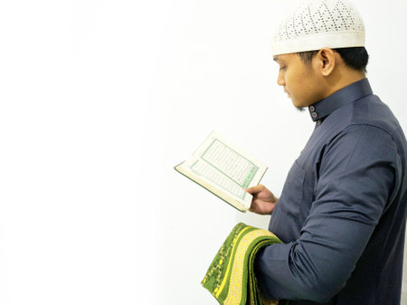 Man Holding and reading quran. Islamic Backgroundの写真素材