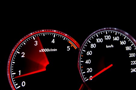 Car dashboard gauges illuminated at night, tachometer, speedometerの写真素材