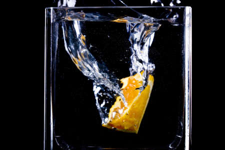 Close up view of the orange  splash in waterの写真素材