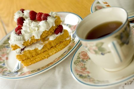 Raspberry cake served with  teaの写真素材