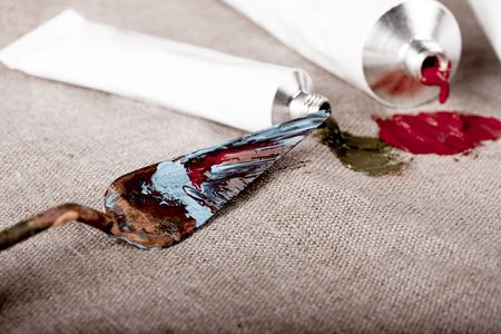 Paint tubes on linen canvas の写真素材