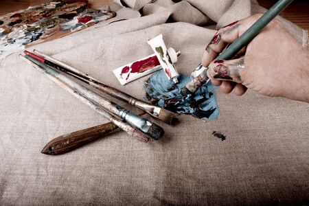 Paint tubes on linen canvas の写真素材