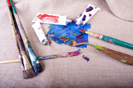 Paint tubes on linen canvasの写真素材