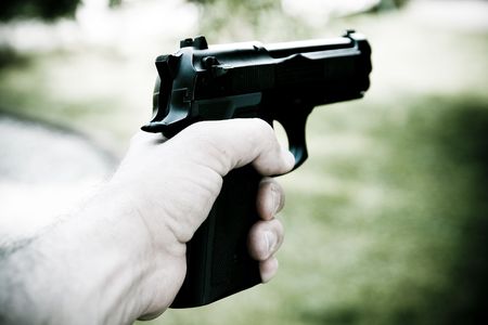 Man holds gun in his handの写真素材