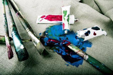 Paint tubes on linen canvas の写真素材