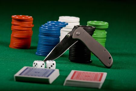  Casino gambling chips, cards and knife  on green tableのeditorial素材