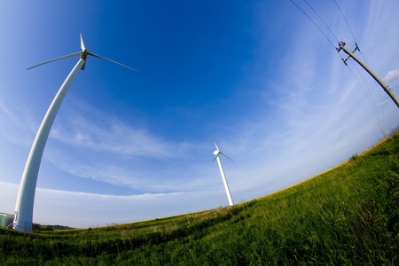 Wind turbine on the meadow shown by fisheye lens