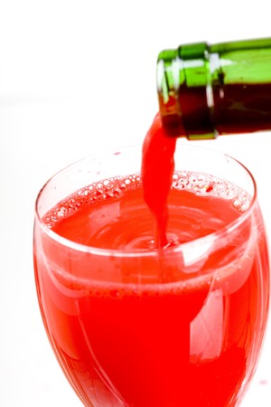 red wine flowing into wineglassの写真素材