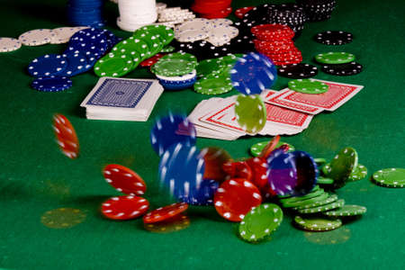  Casino gambling chips and playing cards  on green tableのeditorial素材
