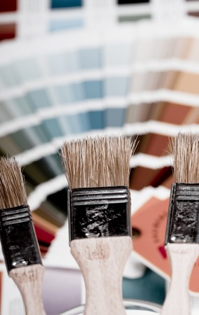 Artistic equipment: paint, brushes and knives on paint backgroundの写真素材