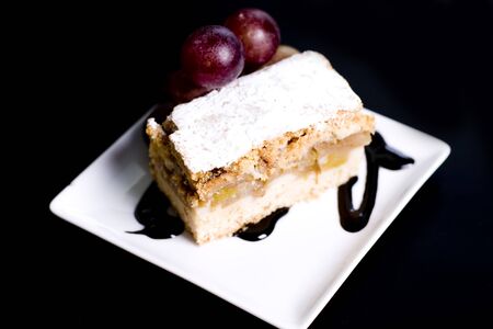 Homemade apple sponge cakes with cinnamon on the white plateの写真素材