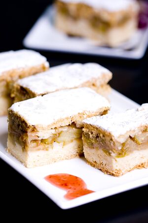 Homemade apple sponge cakes with cinnamon on the white plateの写真素材