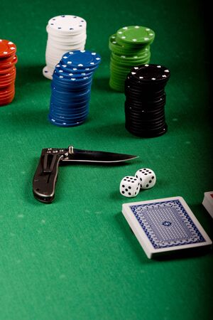 Casino gambling chips, cards and knife  on green tableのeditorial素材