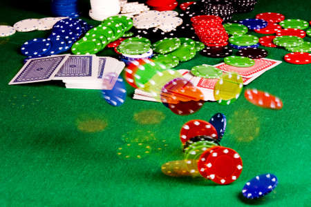  Casino gambling chips and playing cards  on green tableのeditorial素材
