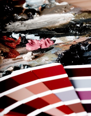 Artistic equipment: paint, brushes and knives on paint backgroundの写真素材