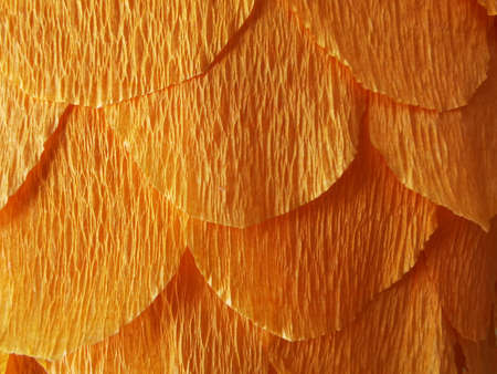 corrugated paper background made from orange cut paperの写真素材