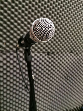 microphone in a recording studio on the background of soundproof paralon panelsの写真素材