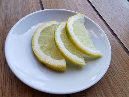 Three lemon slices for tea on a table in a street cafe, a healthy lifestyle and vitaminsの写真素材