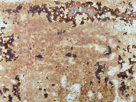 rust creeps through old white paint for the backgroundの写真素材
