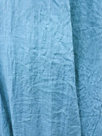 crumpled blue fabric with two vertical folds