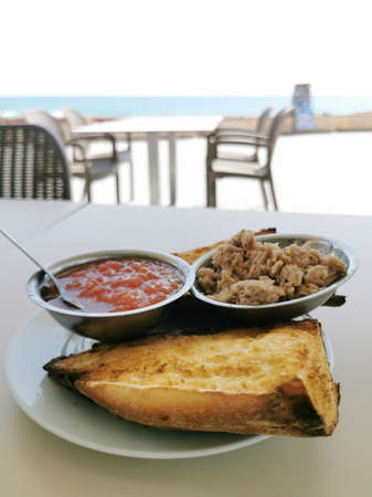 Mediterranean breakfast, bread with tuna and grated tomato