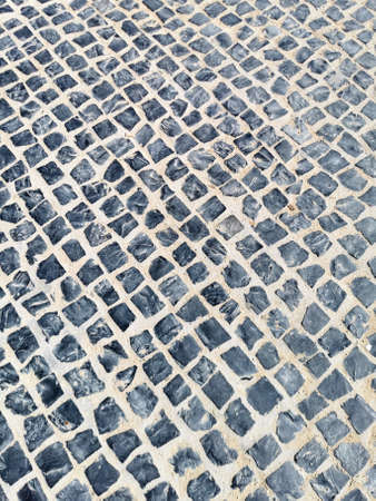 Pavement top view. road paved with gray cobblestones View from above.