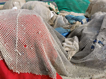 fishing nets and tackles drying on the pavement