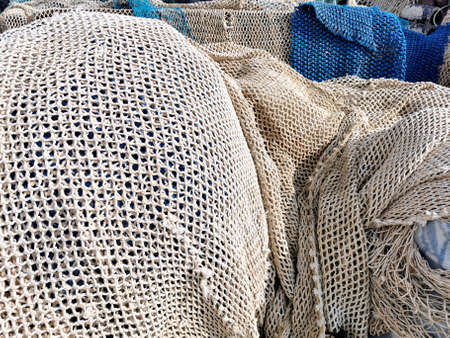 fishing nets and tackles drying on the pavement