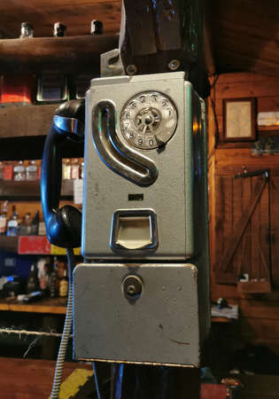 Closeup antique dial telephone on bar counter