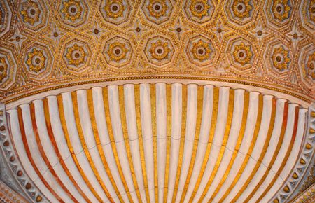 Fragment of beautiful ceiling with gold flowers. Abstract wooden lines with brown details. Old style.  Spain. Toledo. Castiliaの写真素材