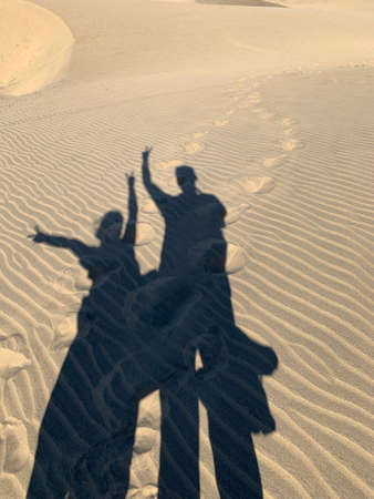 Shapes of two people and footprints on the sand, Maspalomas Gran Canariaの写真素材
