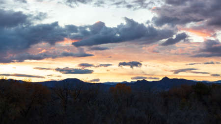 Beautifull sunset shot overlooking a forest with the Wet Mountains in the background.の写真素材