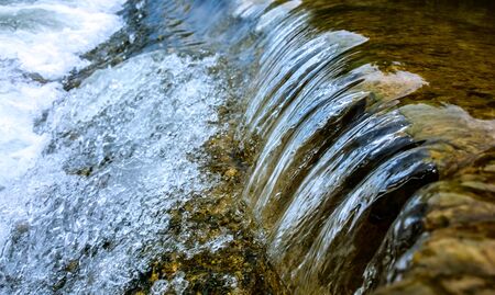 A tiny waterfall in a riverの写真素材