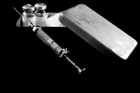 syringe and medicaments on a black backgroun の写真素材