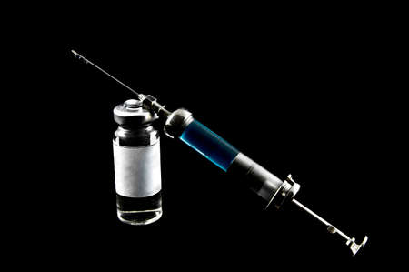 syringe and medicaments on a black backgroun の写真素材