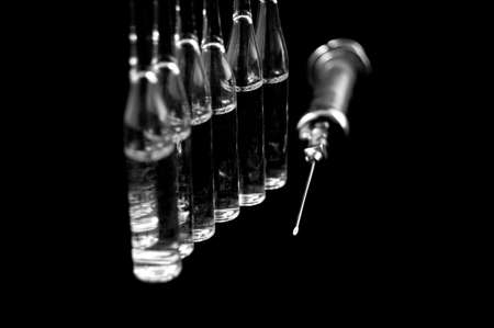 syringe and medicaments on a black backgroun の写真素材