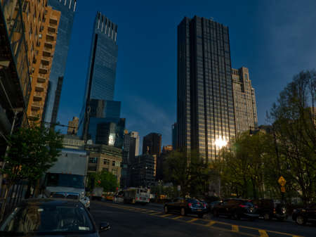 Traffic and sun light of the summer atmosphere in the middle of high rise buildings in New York City