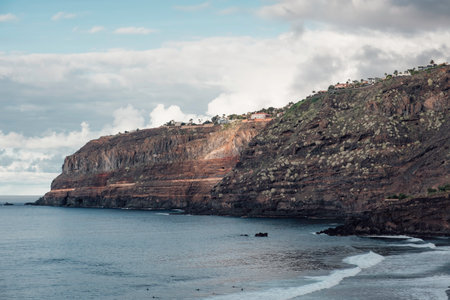 An impressive cliff along the coastline with light effect at the end of day in Tenerife in the Canary islandsの写真素材