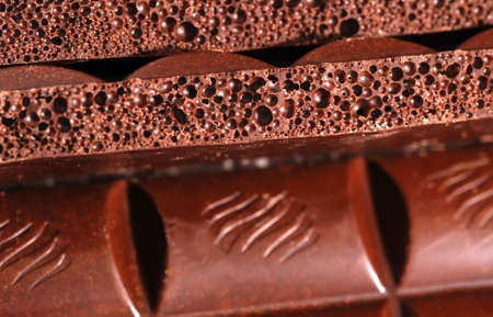 Chocolate. The broken tile of porous black chocolateの写真素材
