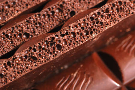Chocolate. The broken tile of porous black chocolateの写真素材