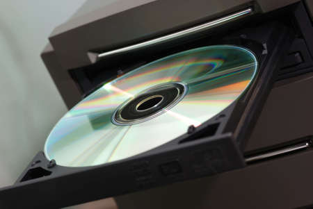 Disk in the  drive. A photo close up CD of a diskの写真素材