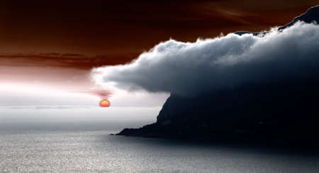 Sunset. A picturesque sunset with fantastic foggy under mountainの写真素材