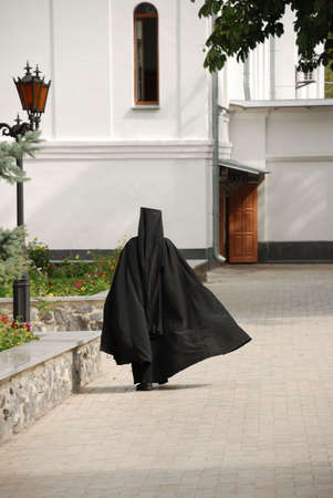 The running monk. The man in a cassock - the novice of a man's monasteryの写真素材