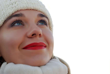 The girl in winter clothes. On a background of the blue skyの写真素材