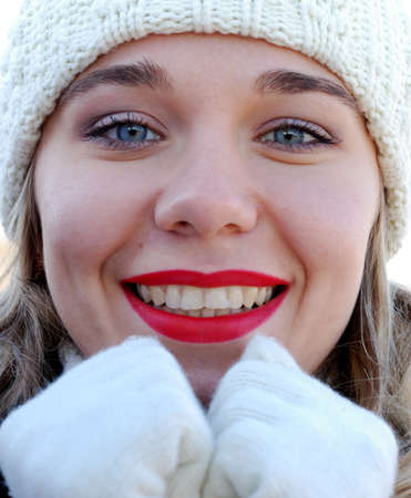 The girl in winter gloves. Winter clothes of white colorの写真素材