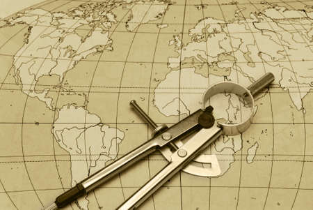 divider and card. The tool for measurement of distance with a card of the world
