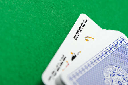 joker.Playing cards on a green background. Poker cardsのeditorial素材