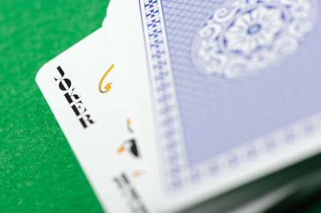 joker.Playing cards on a green background. Poker cardsのeditorial素材