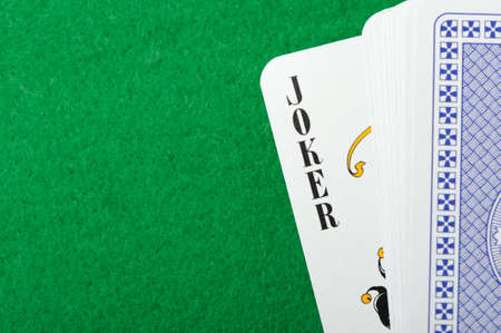 joker.Playing cards on a green background. Poker cards