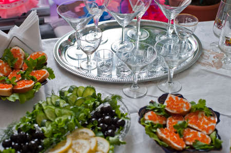 Buffet table. A table with glasses and easy snackの写真素材